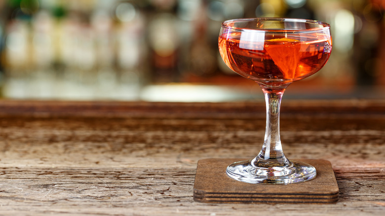 An El Presidente cocktail on a wooden bar