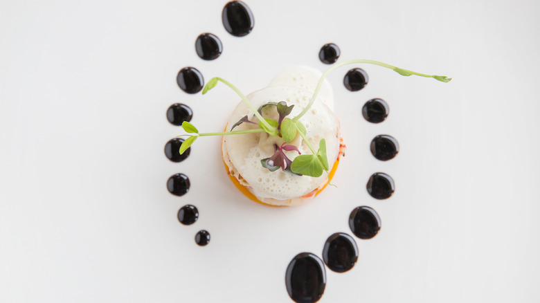 Curved line with sauces on a plate