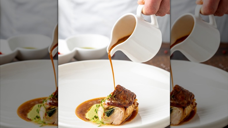 Person pouring sauce on a plate