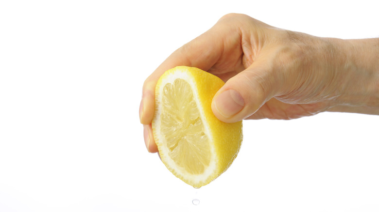 Hand squeezing lemon