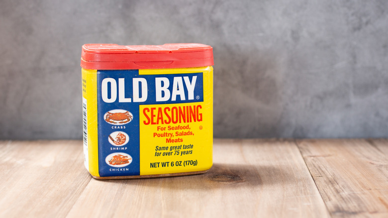 Container of Old Bay seasoning on a wooden surface