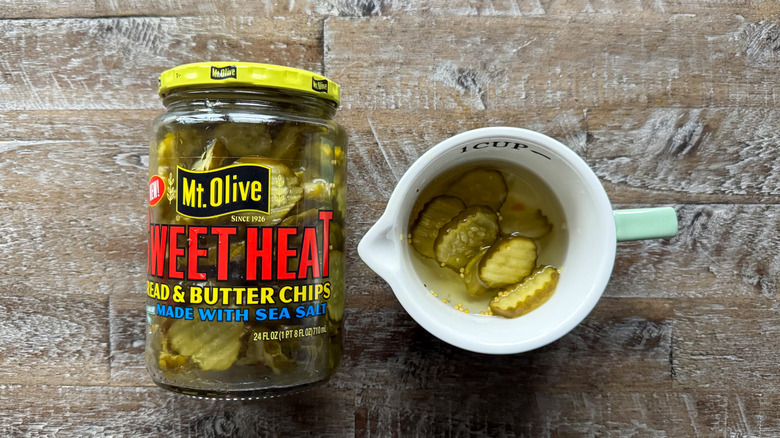 Mt. Olive sweet heat bread and butter pickles on wooden surface