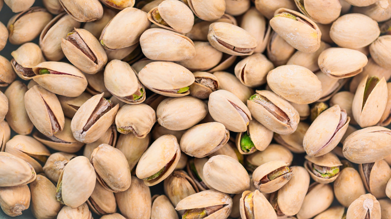 A pile of pistachios with shells