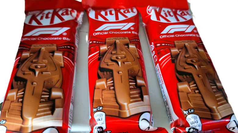 A close-up of three KitKat Formula 1 chocolate bars on a white background