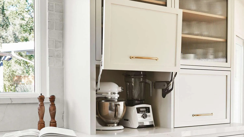 A kitchen appliance garage with mixer and blender inside