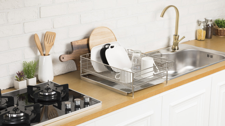 A modern kitchen with a stainless dish drying rack
