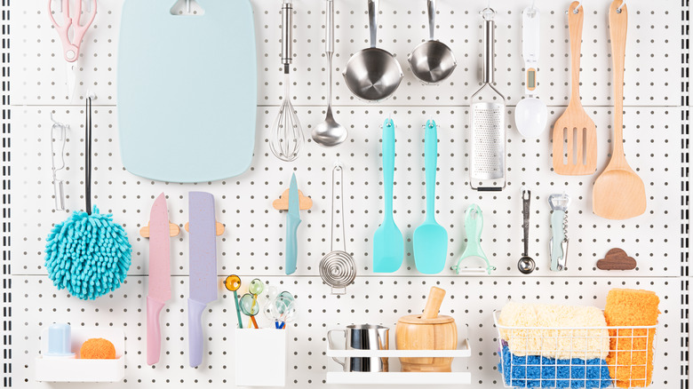 Neatly organized kitchen utensils on pegboard