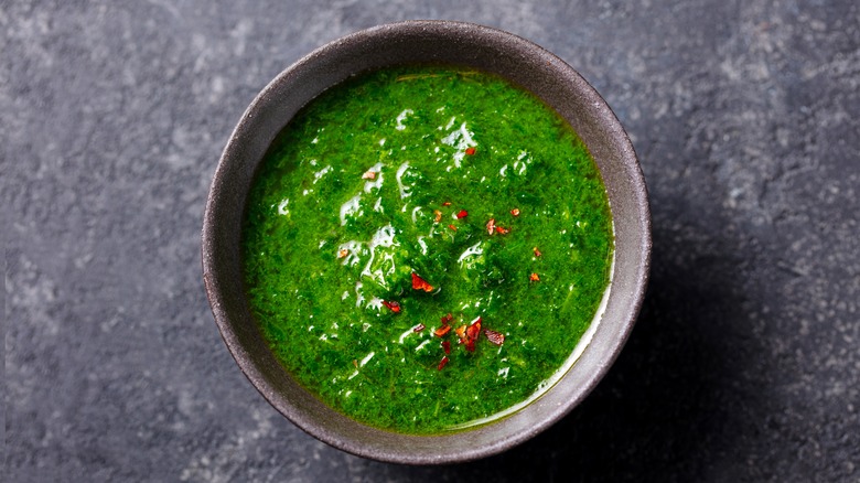 Black bowl of chimichurri sauce