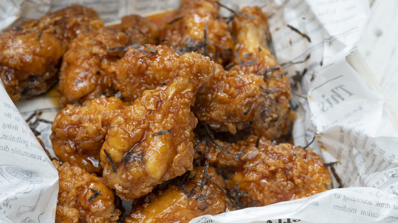 Sauced, fried wings in basket