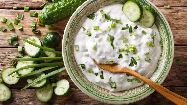 Bowl of raita and sliced cucumbers