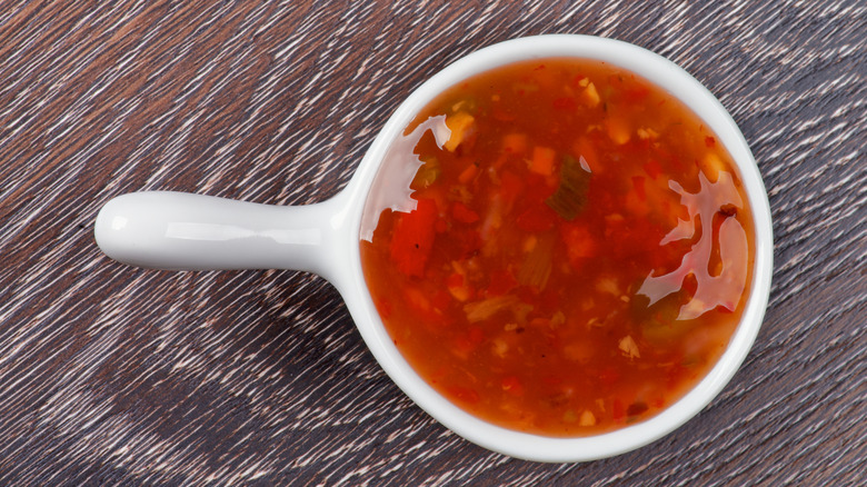Sweet and sour sauce on wooden table