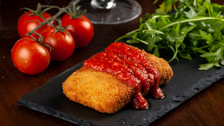 mozzarella en carrozza topped with marinara sauce