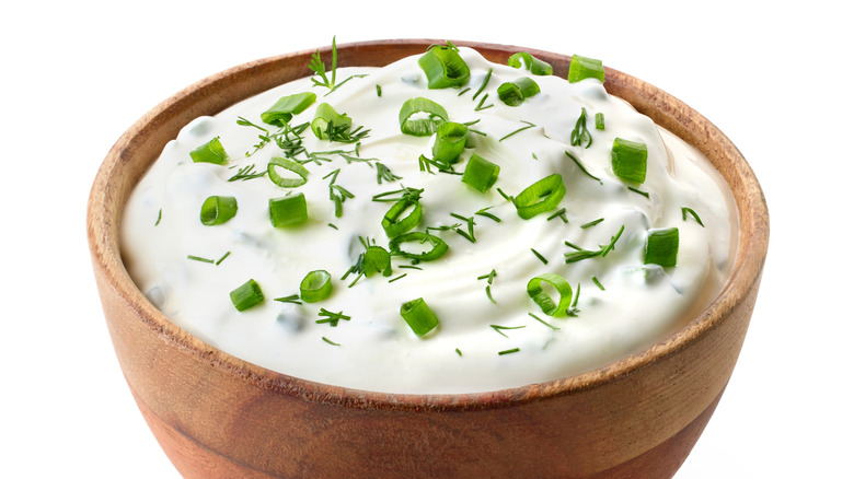 Wood bowl of sour cream dill dip