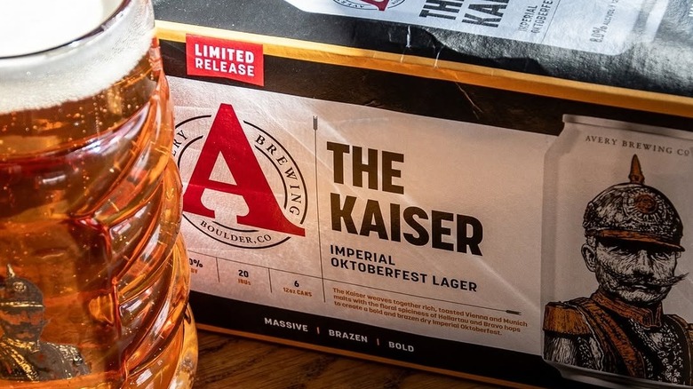 A six-pack of Avery The Kaiser and logo stein are on a table.