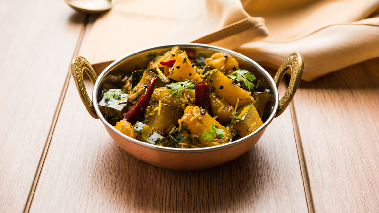 A copper bowl of kaddu ki sabzi