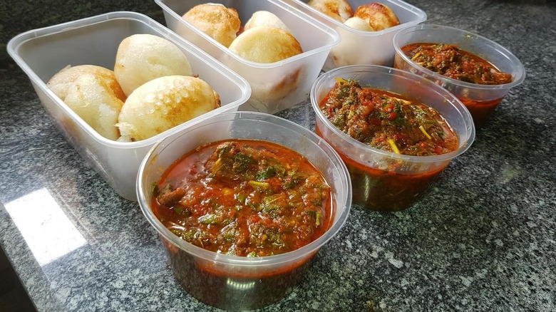 Takeaway containers of miyan taushe stew and bread
