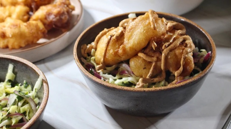 a Baja fish taco bowl with protein on top of coleslaw
