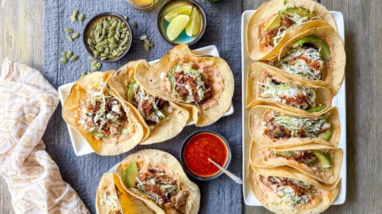platters of grilled mushroom tacos with salsa macha crema and coleslaw inside