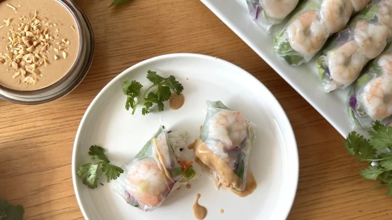 a plate of Vietnamese Shrimp Summer Rolls and Peanut Sauce