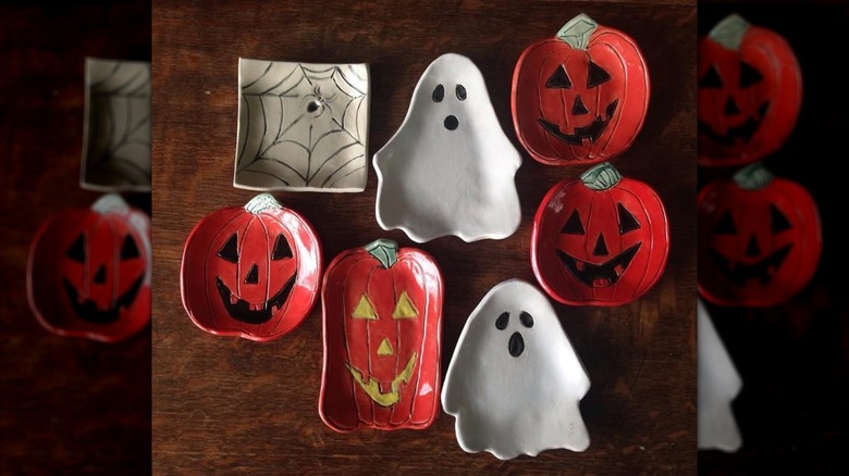 Assorted handmade Halloween-themed spoon rests on wooden table