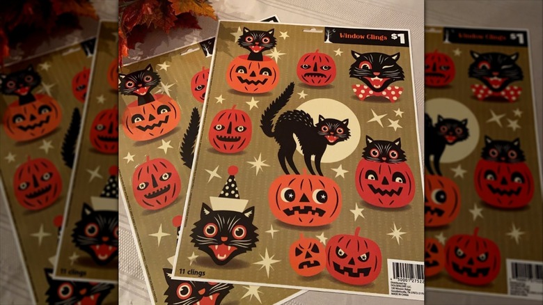 Sheet of vintage Halloween window clings including pumpkins and black cats
