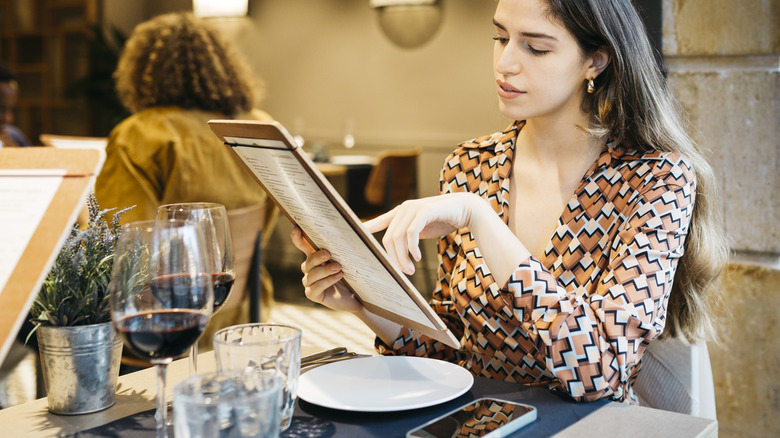 Woman reading a restaurant menu