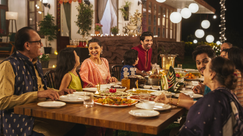 Indian family dining outdoors at restaurant
