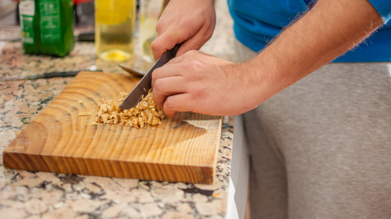 Nuts are chopped on a cutting board