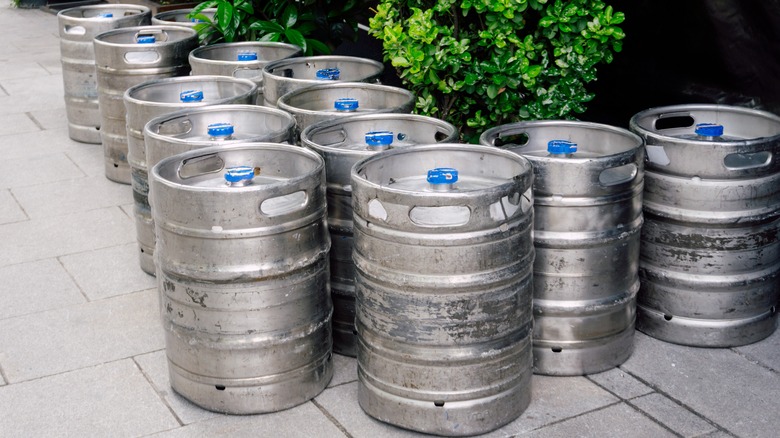A collection of kegs on a sidewalk