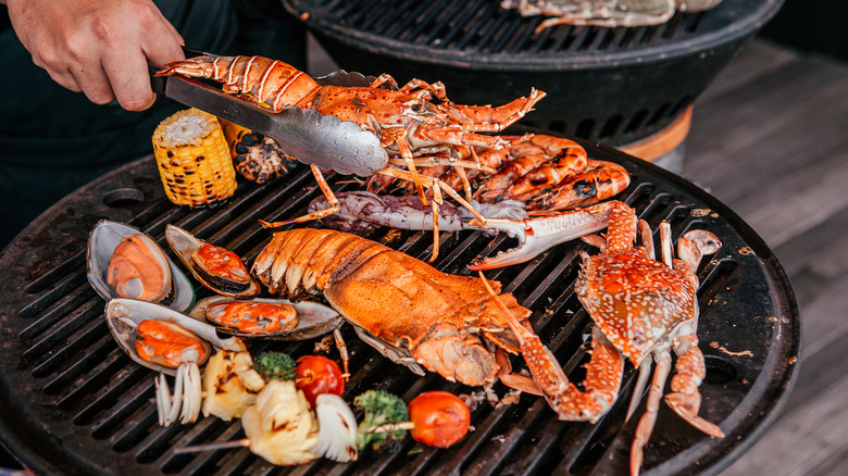 Crab and lobster cooking on grill