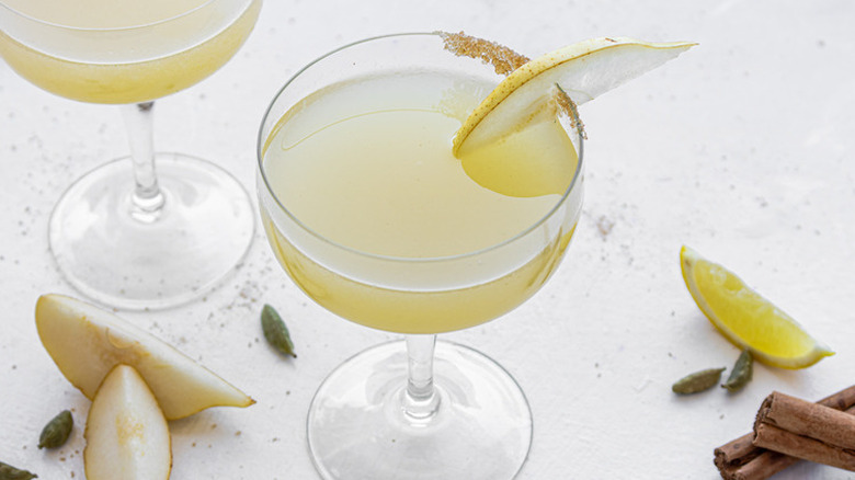 Sugar and spice pear martinis with scattered ingredients