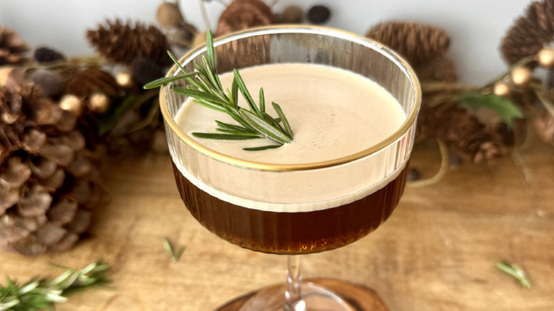 epresso martini with rosemary sprig on wooden table