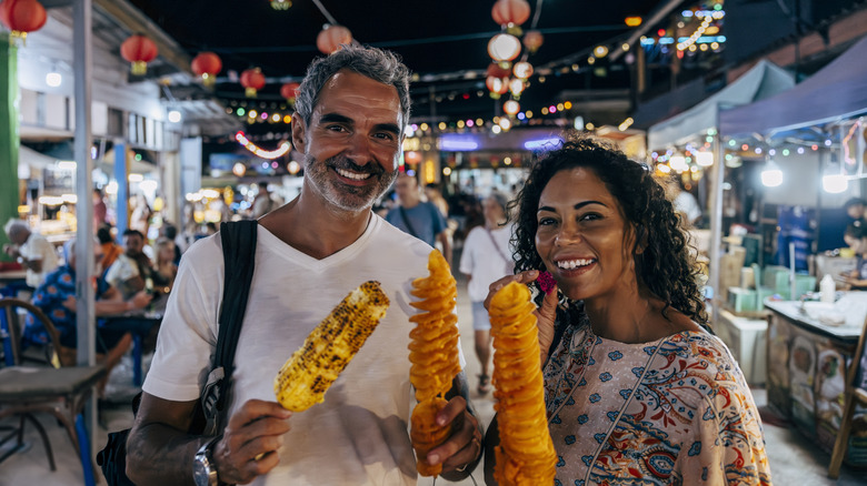 Happy couple enjoying eats at a U.S. night market