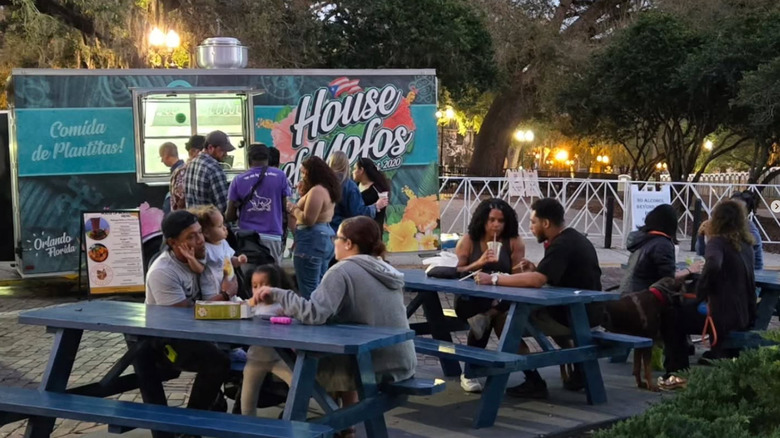 Families eating at the House of Mofos food truck at TPD