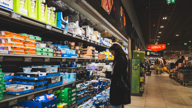 A woman looks at Aldi grocery offerings