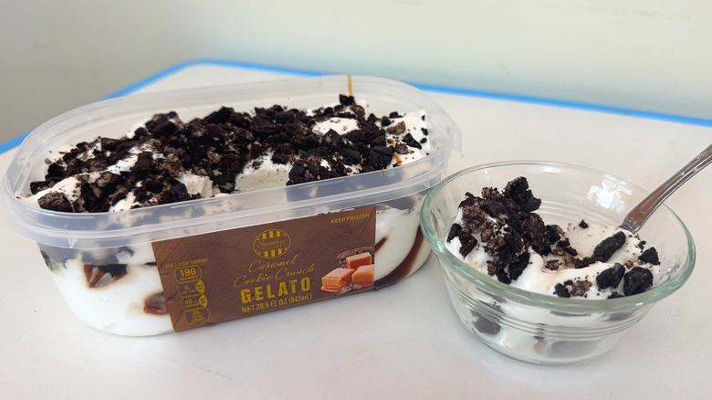 Tub of Sundae Shoppe Caramel Cookie Crunch Gelato beside small filled bowl