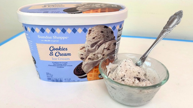 Tub of Sundae Shoppe Cookies & Cream Ice Cream beside small filled bowl