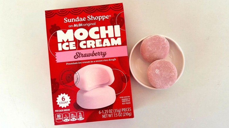 Box of Sundae Shoppe Strawberry Mochi Ice Cream beside small white dish with two mochi pieces
