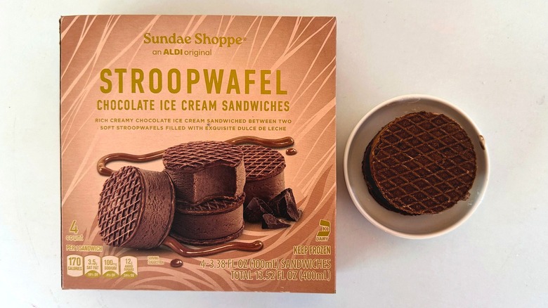 Box of Sundae Shoppe Stroopwafel Chocolate Ice Cream Sandwiches beside one sandwich in small dish
