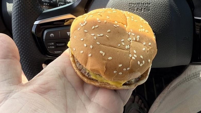 A person holding a Double Cheeseburger from Burger King