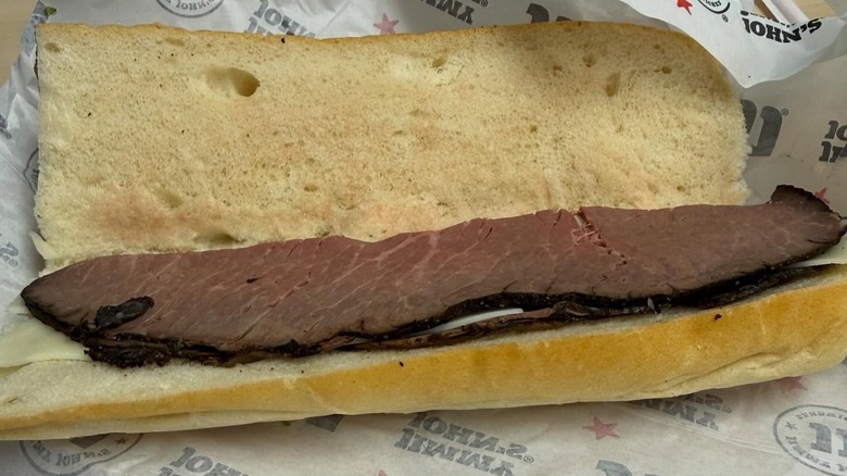 A roast beef sub from Jimmy John's open on a wrapper