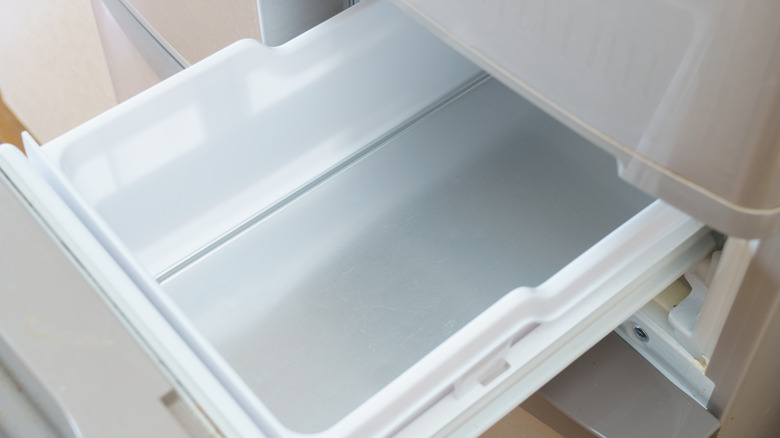 An empty refrigerator or freezer drawer