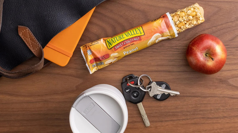 nature valley bar with apple and keys on table