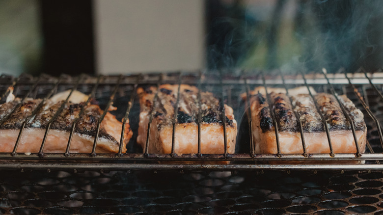 Grilling salmon on a barbecue rack