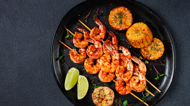 Grilled shrimp with other foods on a plate
