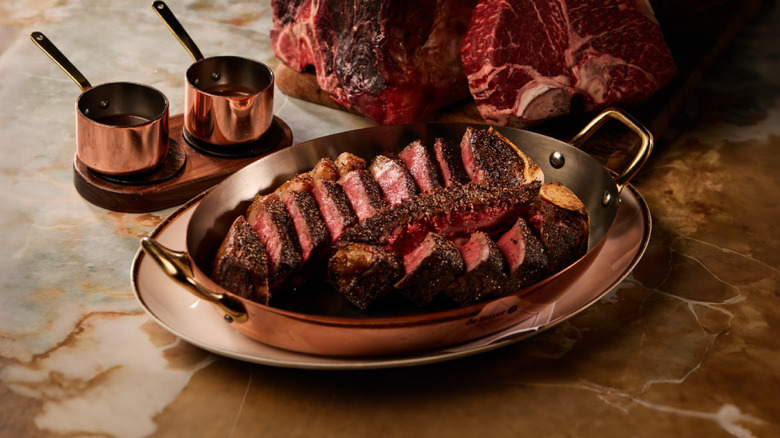 Steak from SW steakhouse in a dish on a marble surface