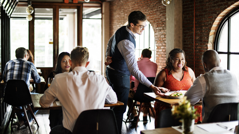 Busy restaurant with staff and patrons