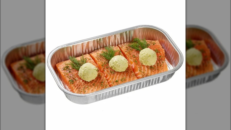 A tray of salmon with herb butter and dill
