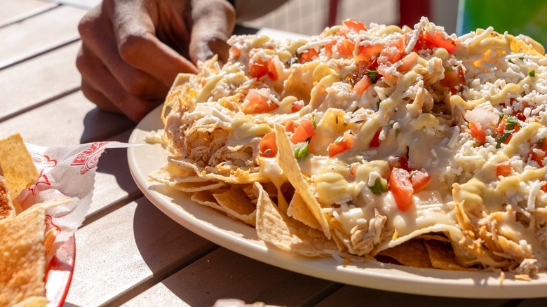 A plate of nachos on a table at Fuzzy's Taco Shop