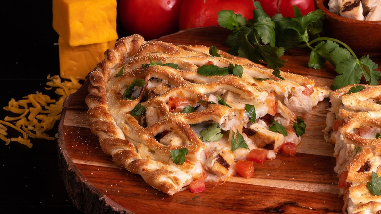 A calzone on a wooden cutting board at Calzone Life